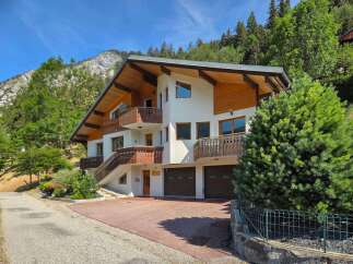 Experience luxury mountain living in this stunning chalet, featuring a modern design with warm wood accents and expansive balconies offering breathtaking views.