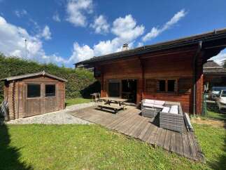 Experience outdoor living at its finest with this charming wooden cabin featuring a spacious deck perfect for entertaining.