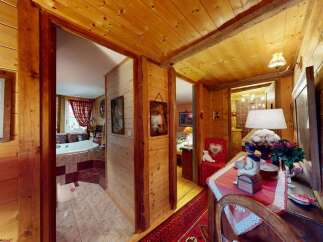 Experience rustic charm in this cozy log cabin interior, featuring a luxurious bathroom with a soaking tub and scenic views.