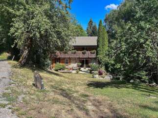 Nestled amidst lush greenery, this charming stone-built chalet offers a serene mountain retreat.