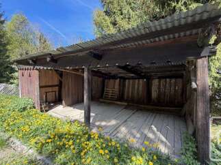 Discover this charming wooden structure, perfect for storage or as a rustic shelter.