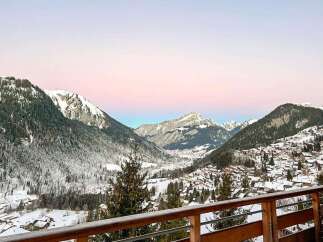Experience breathtaking mountain views from this stunning property, nestled amidst snow-covered peaks and a charming village.