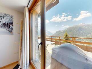Experience breathtaking mountain views from this stunning property, featuring a spacious balcony perfect for enjoying the alpine scenery.