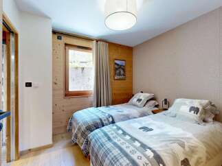 This charming bedroom features two cozy twin beds, perfect for accommodating guests or family.