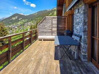 Enjoy breathtaking mountain views from this charming wooden balcony, perfect for al fresco dining or simply relaxing in the fresh air.