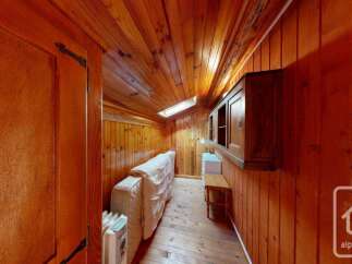 Experience cozy living in this charming wooden cabin, featuring a comfortable sofa bed perfect for relaxation.