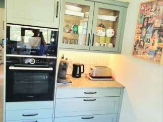 Discover this charming kitchen featuring a sleek built-in oven and microwave combination, complemented by stylish light blue cabinetry.