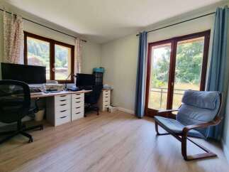This home office features two spacious desks, perfect for dual workstations or creative projects.