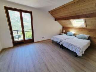 This charming attic bedroom features two comfortable twin beds, perfect for accommodating guests or family.