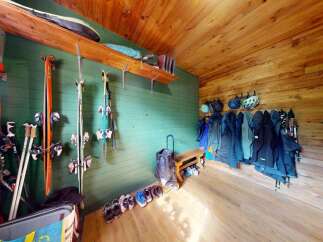 This ski storage area is perfect for outdoor enthusiasts, featuring ample wall-mounted racks for skis and poles.