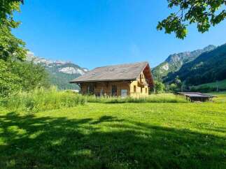 Nestled amidst breathtaking mountain scenery, this charming wooden chalet offers a serene escape.
