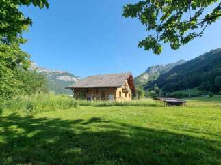 Nestled in a serene mountain landscape, this charming wooden chalet offers a tranquil retreat.