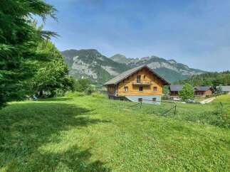 Experience serene mountain living in this charming wooden chalet, nestled amidst lush green meadows and breathtaking alpine scenery.