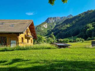 Experience serene mountain living in this charming wooden chalet, nestled amidst lush green meadows and towering forests.