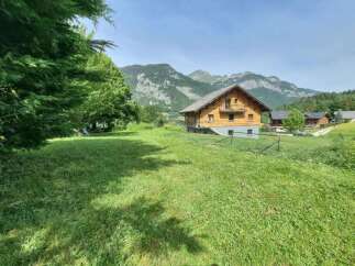 Experience serene mountain living in this charming wooden chalet, nestled amidst lush green meadows and breathtaking alpine scenery.