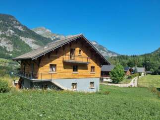 Nestled in a serene mountain landscape, this charming wooden chalet offers a perfect retreat.