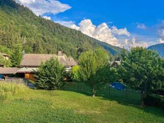 Nestled amidst lush greenery and rolling hills, this charming property offers a serene mountain retreat.