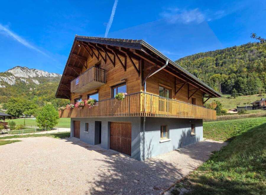 Experience the charm of this beautiful wooden chalet nestled in a serene mountain landscape.