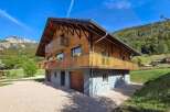 Experience the charm of this beautiful wooden chalet nestled in a serene mountain landscape.