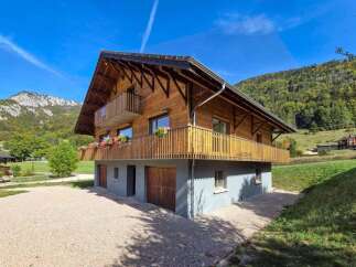 Experience the charm of this beautiful wooden chalet nestled in a serene mountain landscape.