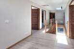 Step into this beautifully designed hallway, featuring light wood-look flooring and a modern aesthetic.