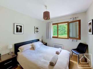 This charming bedroom features a comfortable king-size bed with plush pillows and soft linens, perfect for a restful night's sleep.