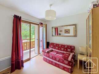 This cozy living space features a comfortable sofa bed adorned with a charming heart pattern, perfect for relaxing or accommodating guests.