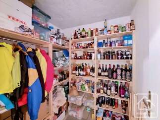 Discover ample storage solutions in this property, featuring a well-organized pantry with extensive shelving for groceries and preserves.