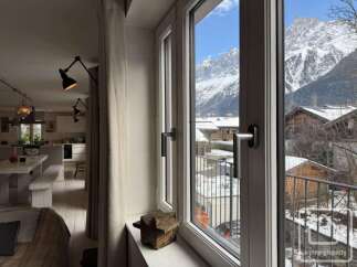 Experience breathtaking mountain views from this charming property, perfect for those seeking a serene alpine retreat.