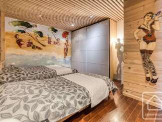 This charming bedroom features two comfortable beds adorned with nature-inspired duvet covers, perfect for a restful night's sleep.