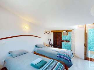 This charming bedroom features two comfortable twin beds, perfect for accommodating guests or family.