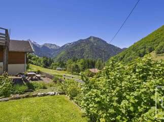 Experience serene mountain living with this charming property nestled amidst lush greenery and breathtaking alpine views.