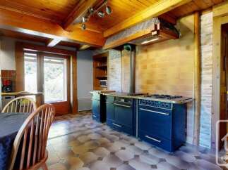 Experience rustic charm in this mountain kitchen featuring a large, traditional range and a cozy dining area.