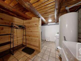 Discover a functional laundry area with a large water heater and washing machine, perfect for managing household chores.