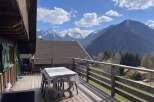 Enjoy breathtaking mountain views from this charming wooden cabin's spacious deck.
