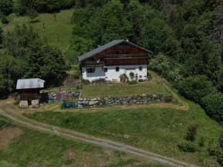 Nestled amidst lush greenery, this charming property offers a serene mountain retreat.