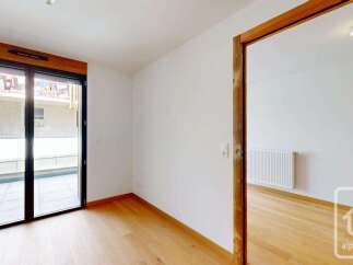 This bright and airy room features a large glass door leading to an outdoor space, perfect for enjoying the fresh air.