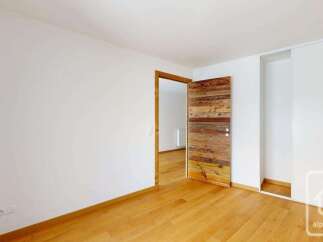 Step into this inviting room featuring a rustic wooden door that adds warmth and character.