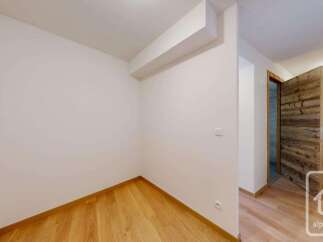 Step into this inviting space featuring warm, natural wood flooring that flows seamlessly throughout the room.