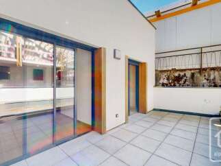 Experience modern living with this spacious balcony, featuring large sliding glass doors that flood the interior with natural light.