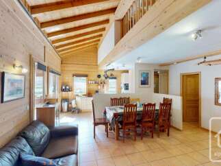 Experience rustic charm in this spacious log cabin featuring an open-plan living and dining area perfect for gatherings.