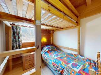 This charming bedroom features a cozy bunk bed setup, perfect for families or groups.