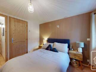 Experience cozy mountain living in this charming bedroom featuring a comfortable bed with plush pillows and a stylish headboard.