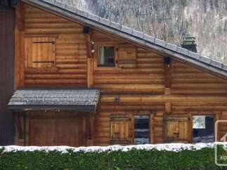 Experience rustic charm in this stunning log cabin, nestled amidst a serene winter landscape.