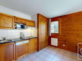 This charming kitchen features warm wooden cabinetry and a practical layout, perfect for preparing meals during your stay.