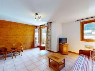 This charming living area features a rustic wooden accent wall, creating a warm and inviting atmosphere.