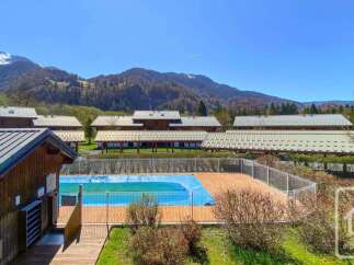 Discover this charming property featuring a refreshing outdoor swimming pool, perfect for summer relaxation.