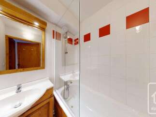 This charming bathroom features a spacious vanity with a large wooden-framed mirror, perfect for your morning routine.