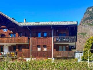 Experience alpine living in this charming wooden chalet, featuring multiple balconies with stunning mountain views.