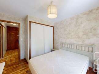 Discover this charming bedroom featuring a comfortable bed and a spacious built-in wardrobe, perfect for storage.